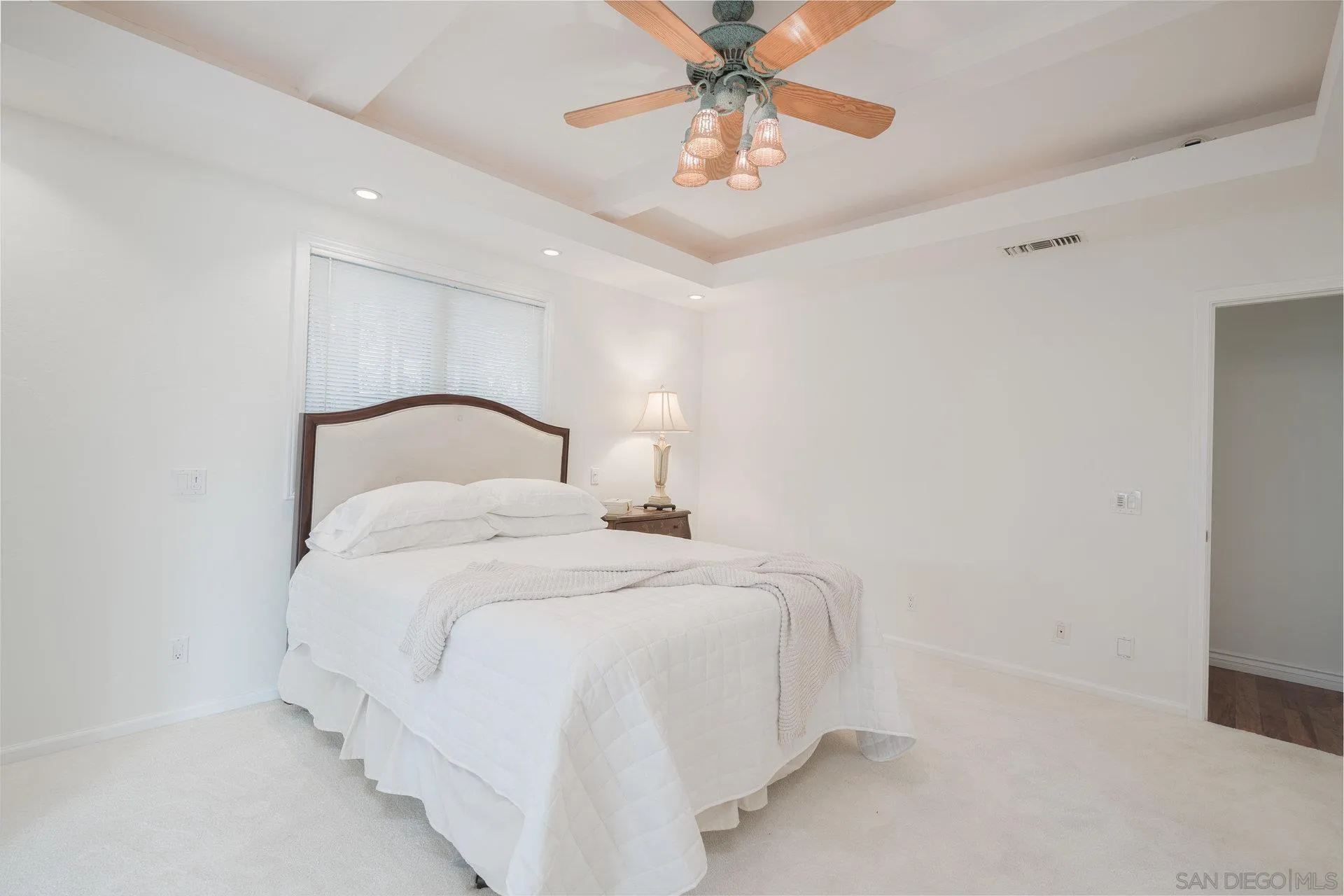 684 Arden Drive Encinitas, CA 92024 - Photo 38 of 59 a bedroom with a bed and a chandelier