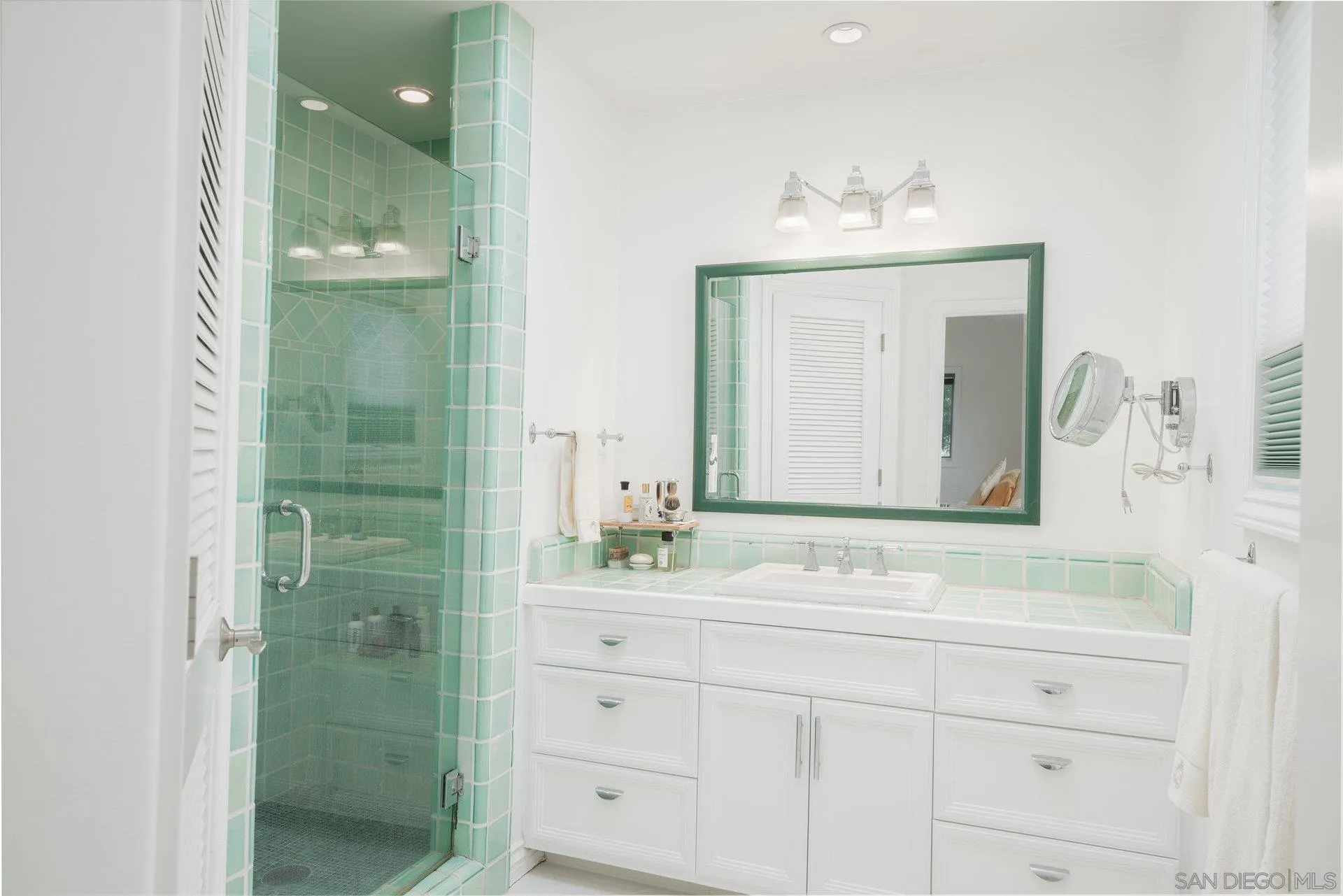 684 Arden Drive Encinitas, CA 92024 - Photo 43 of 59 a bathroom with a sink and a mirror