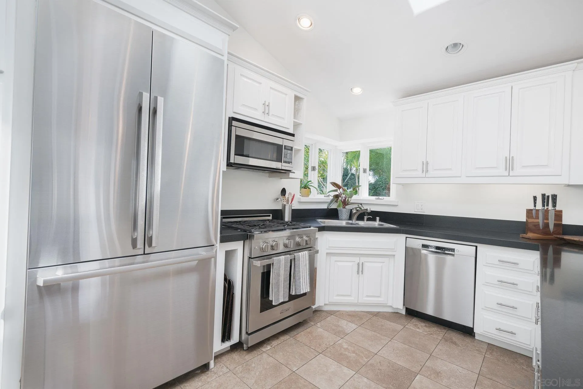 684 Arden Drive Encinitas, CA 92024 - Photo 49 of 59 a kitchen with white cabinets stainless steel appliances and sink