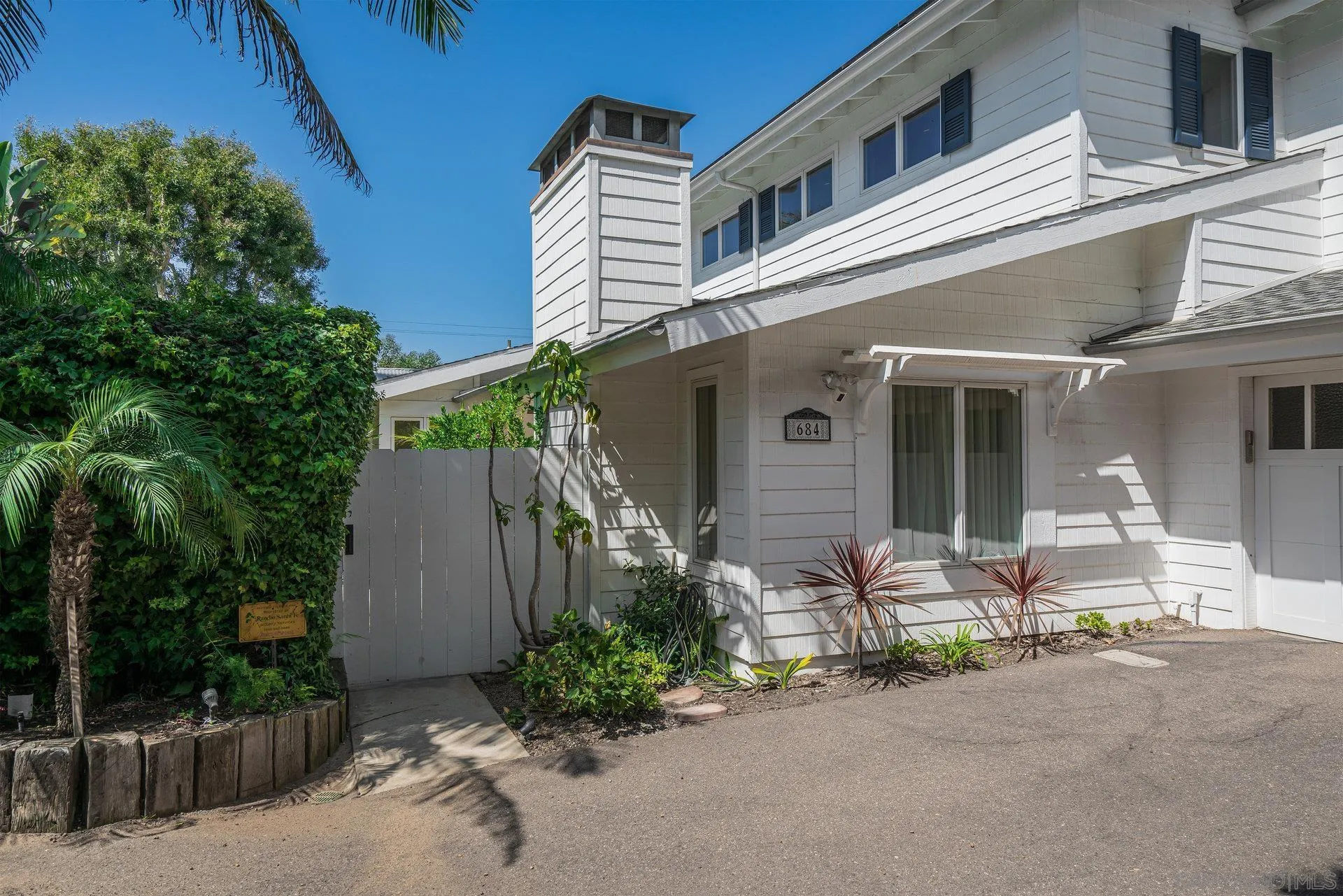 684 Arden Drive Encinitas, CA 92024 - Photo 5 of 59 a front view of a house with outdoor seating and a yard