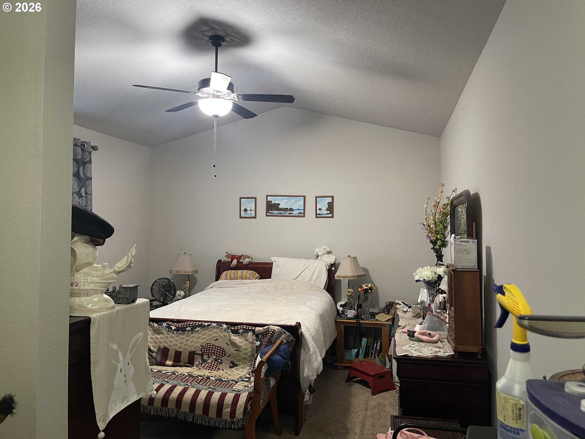 408 Southwest Oak Street Willamina, OR 97396 - Photo 15 of 30 a bedroom with a bed and a chandelier