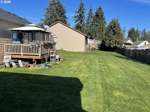 a view of a house with a yard and deck