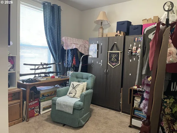 a bed sitting in a bedroom next to a window