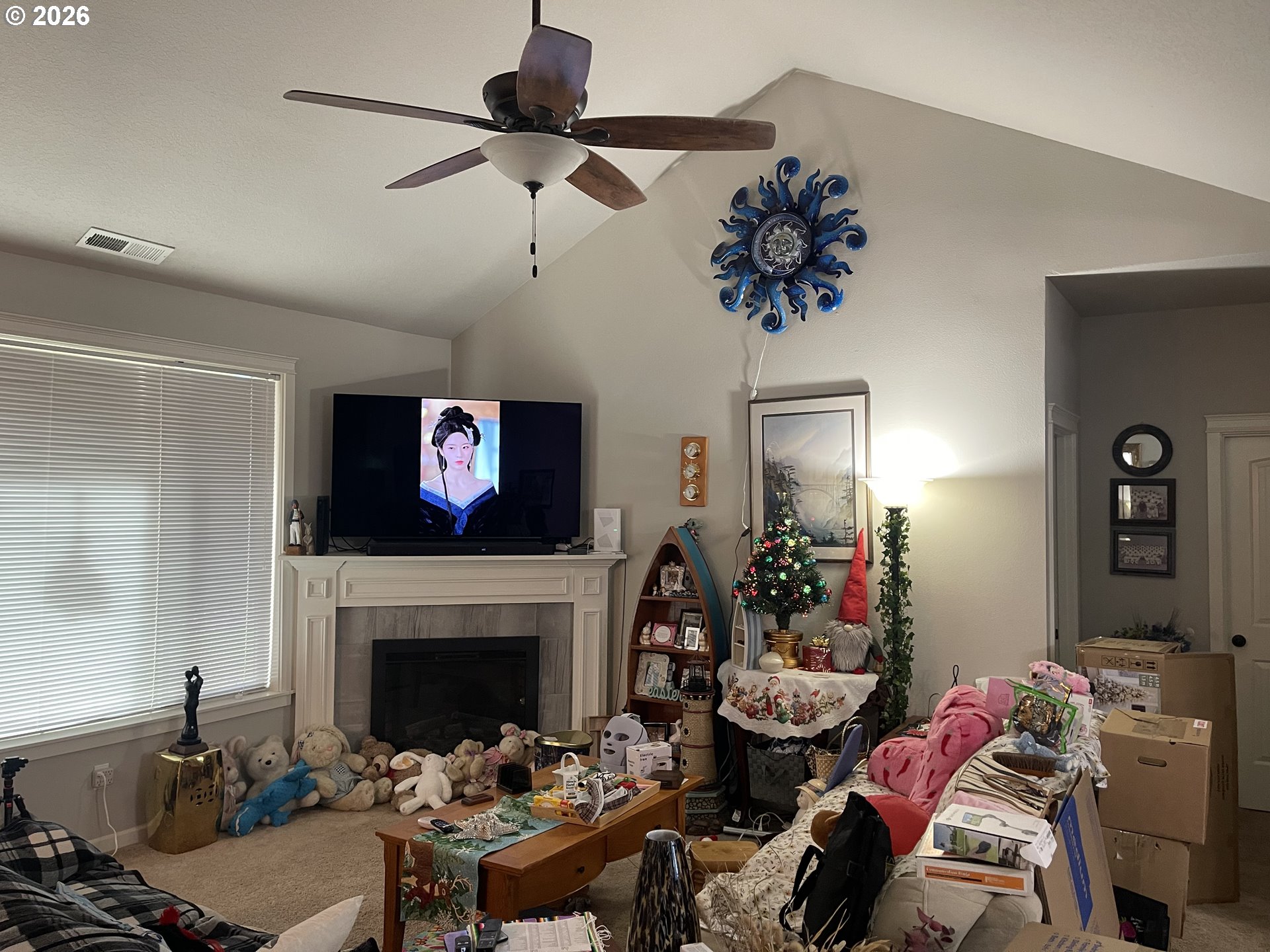 408 Southwest Oak Street Willamina, OR 97396 - Photo 9 of 30 a living room with furniture a fireplace and a chandelier