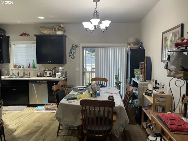a living room with furniture a chandelier and a flat screen tv
