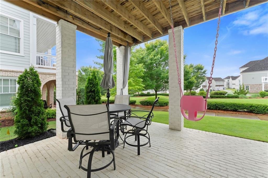 7170 Lullwater Road Cumming, GA 30040 - Photo 76 of 86 a view of a porch with furniture and garden