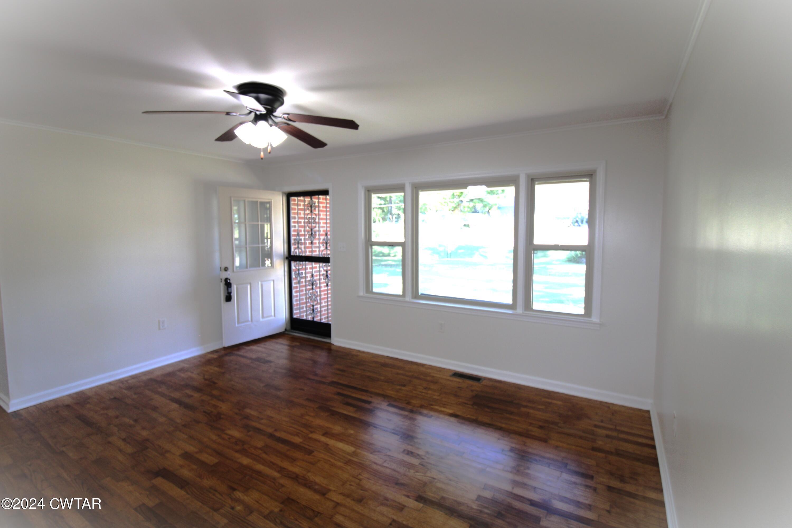 465 Crucifer Road Huron, TN 38345 - Photo 13 of 15 a view of an empty room with a window and wooden floor