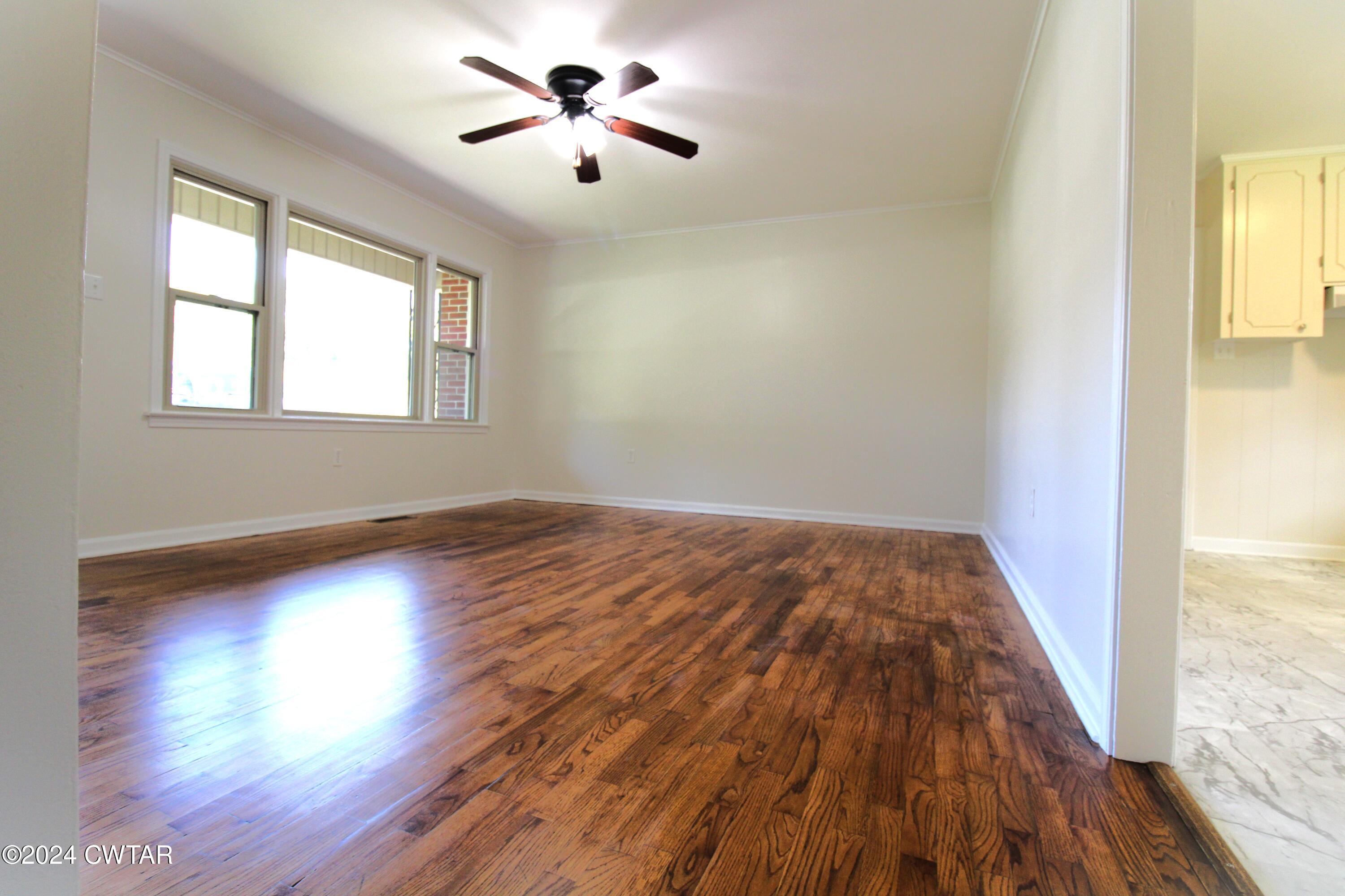 465 Crucifer Road Huron, TN 38345 - Photo 6 of 15 wooden floor in an empty room with a window
