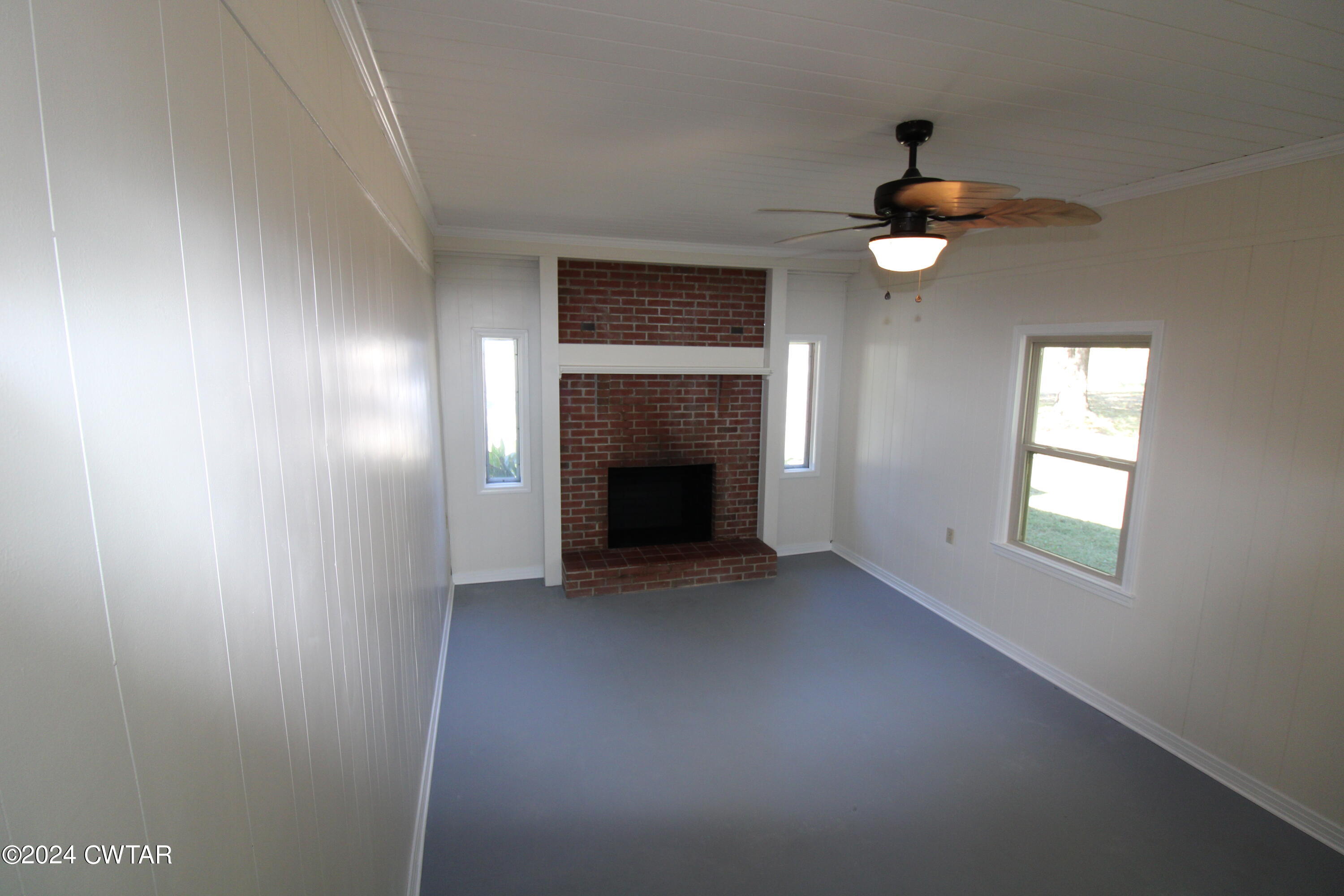 465 Crucifer Road Huron, TN 38345 - Photo 7 of 15 an empty room with windows and fireplace