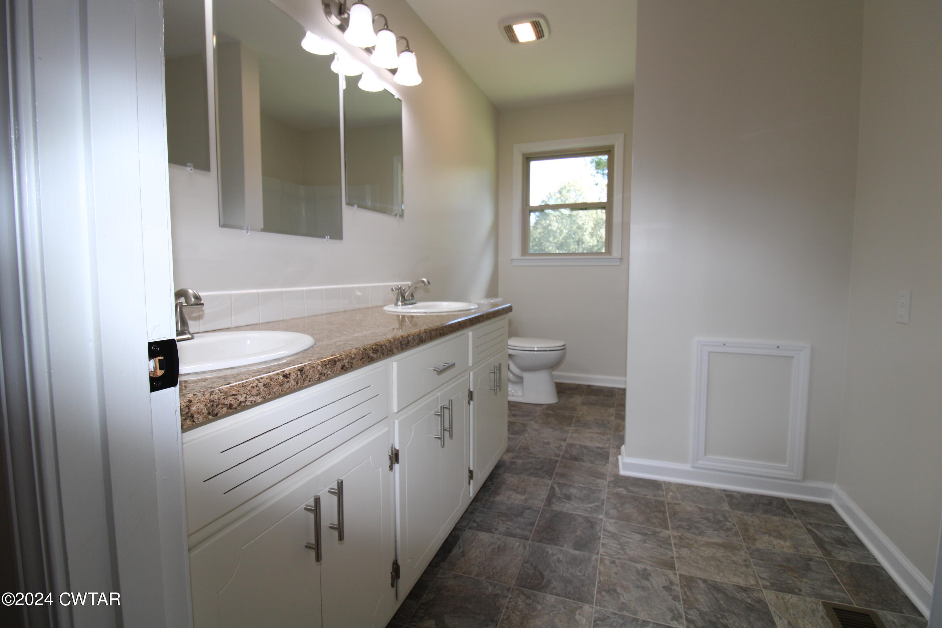 465 Crucifer Road Huron, TN 38345 - Photo 10 of 15 a bathroom with a sink a vanity and a mirror