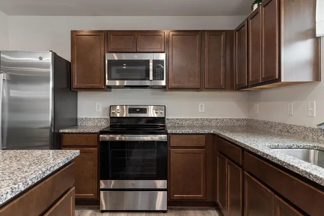 a kitchen with a sink stove and microwave