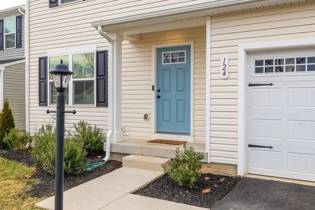 a view of a pathway of the house with potted plants