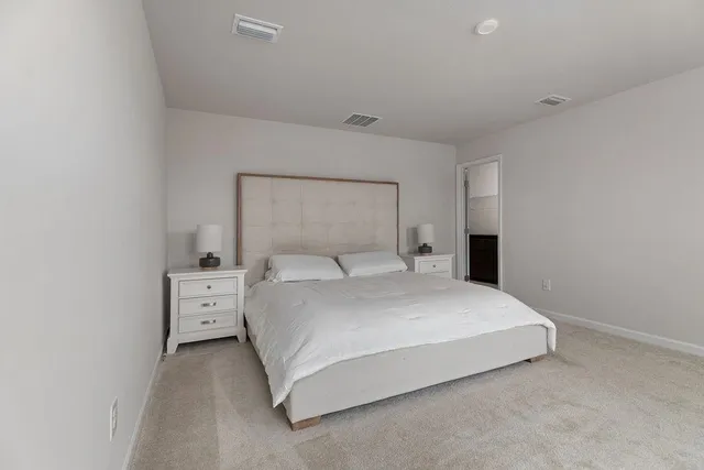a large white bed in a white room