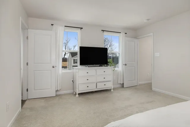 a view of walk in closet with clothes