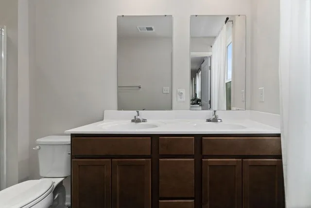 a bathroom with a shower a toilet and sink