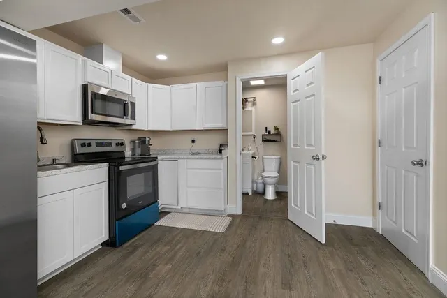 a kitchen with wooden cabinets and stainless steel appliances