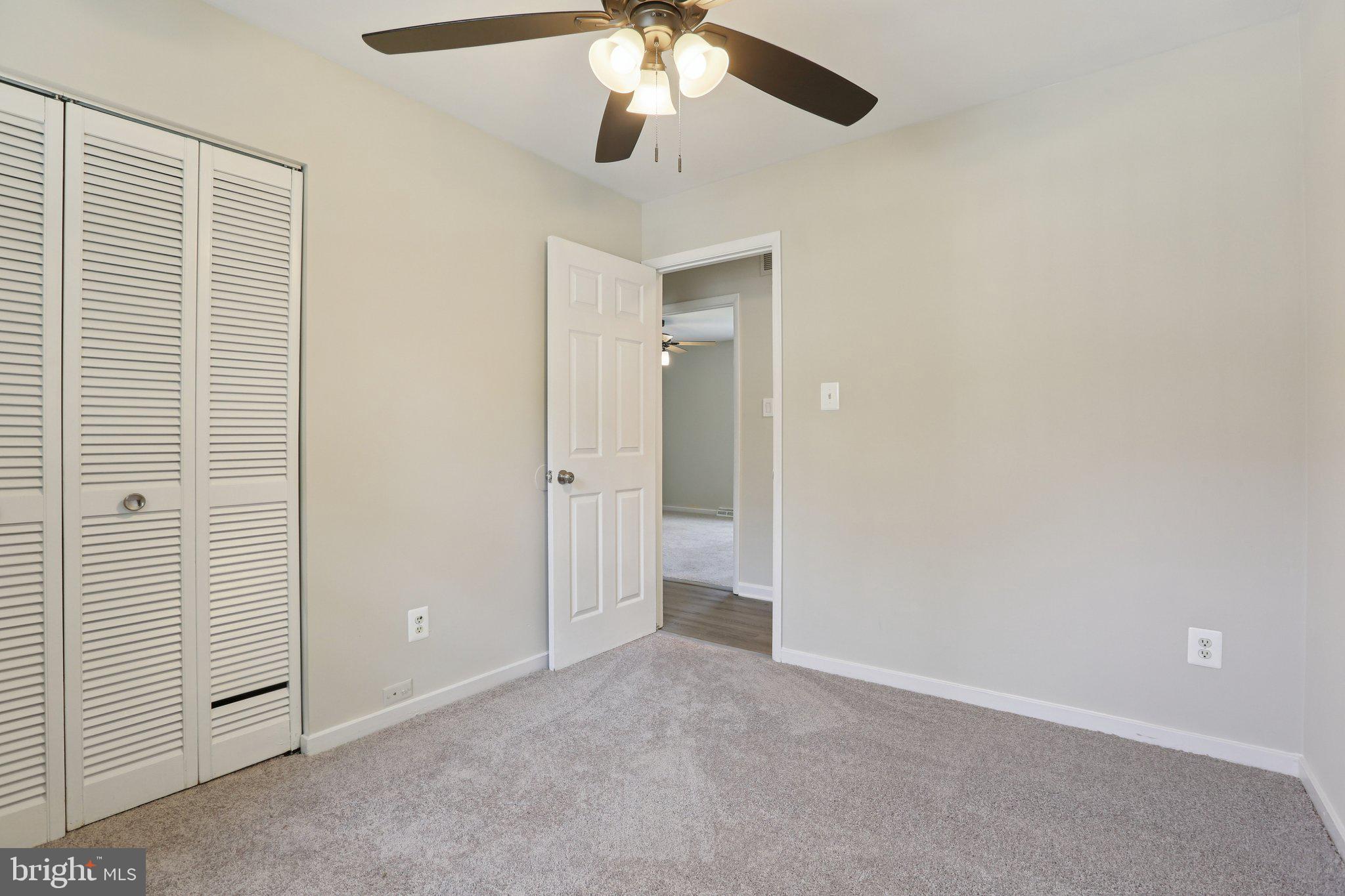 5415 Thunder Hill Road Columbia, MD 21045 - Photo 17 of 54 an empty room with a ceiling fan and a window