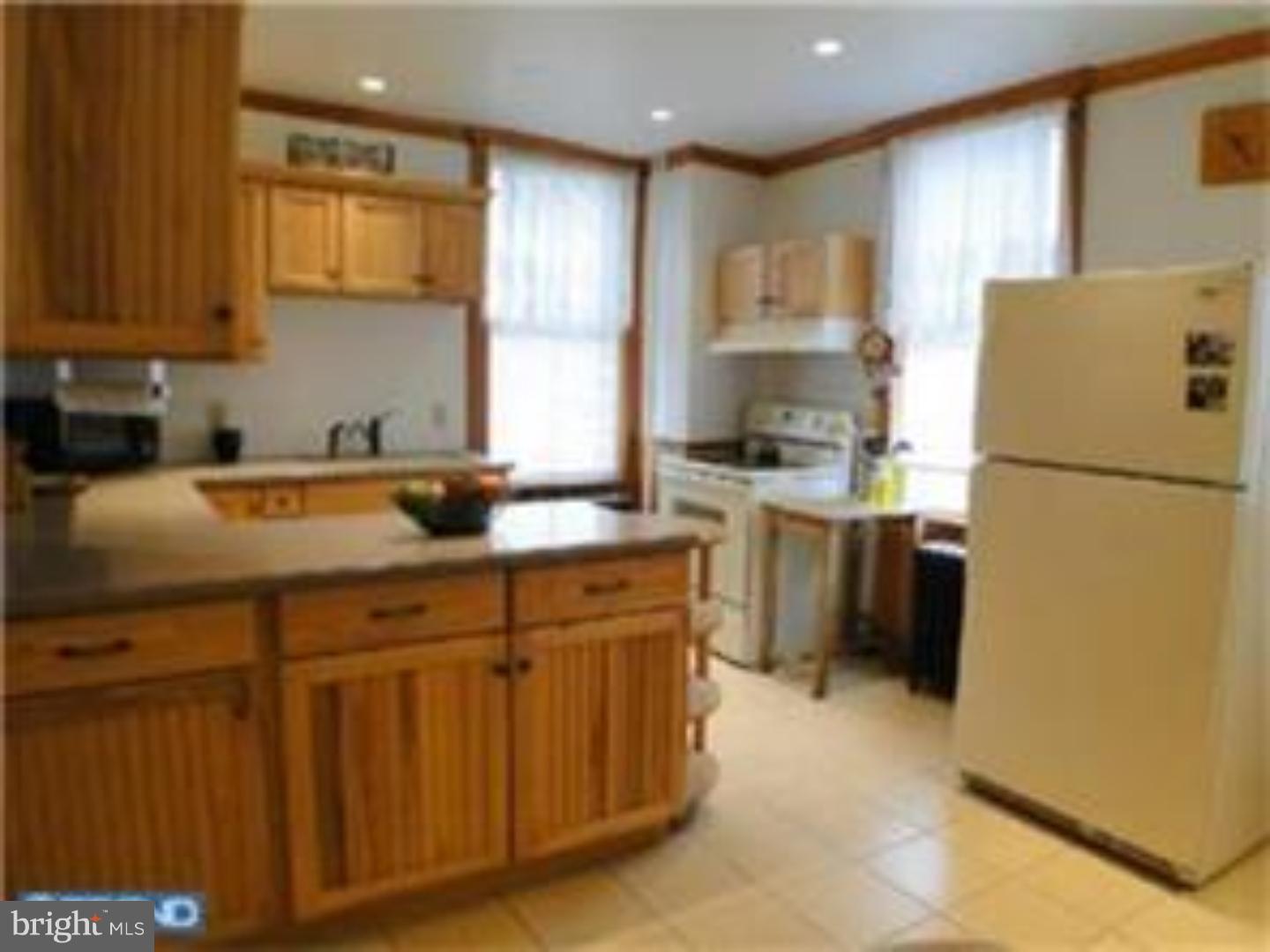 129 Maplewood Road Riegelsville, PA 18077 - Photo 4 of 13 a kitchen with a sink a refrigerator a stove a microwave and cabinets