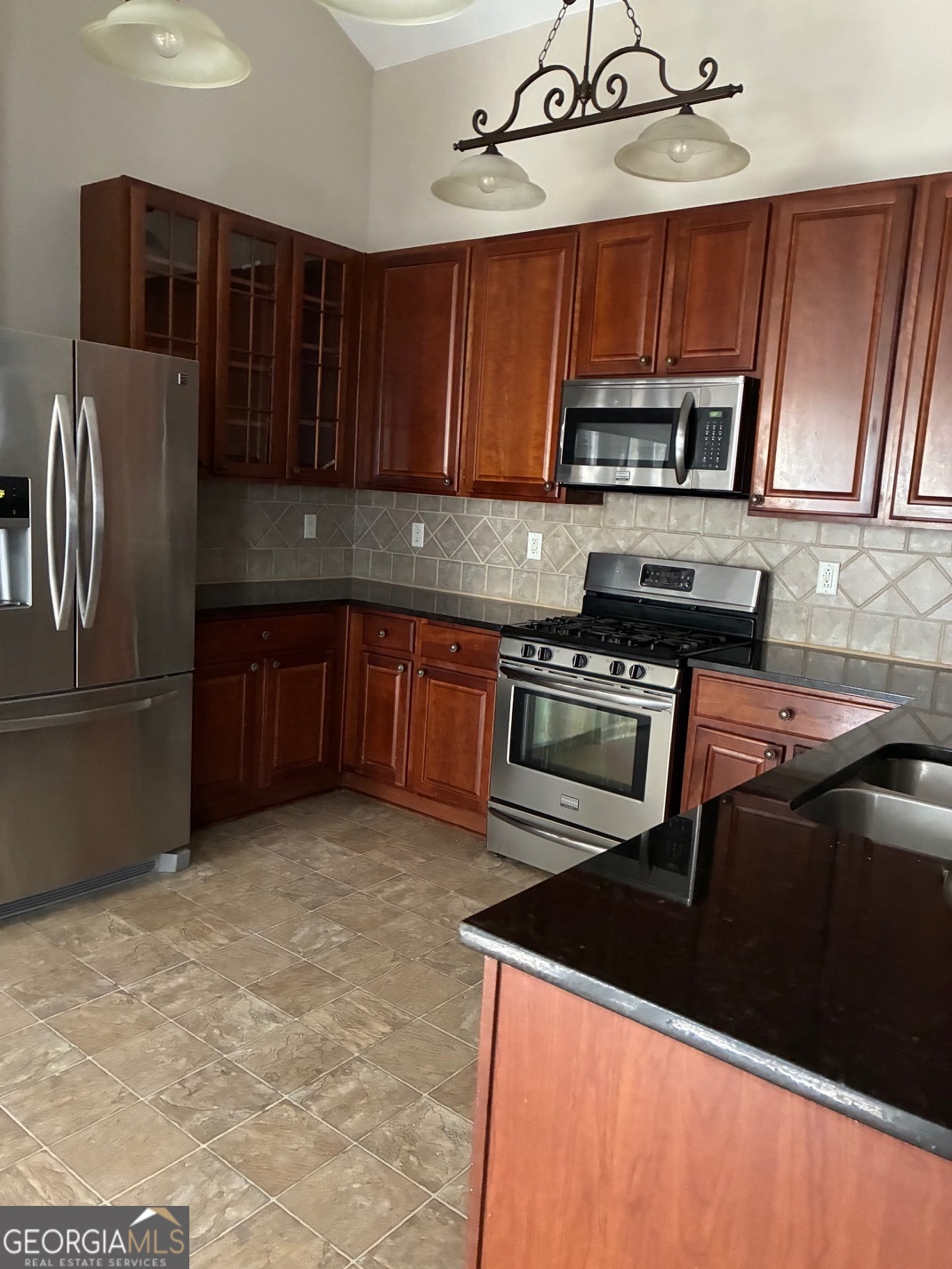 4230 Vinca Way Union City, GA 30291 - Photo 12 of 14 a kitchen with stainless steel appliances granite countertop a stove top oven a sink dishwasher and a microwave oven on the blue kitchen countertops