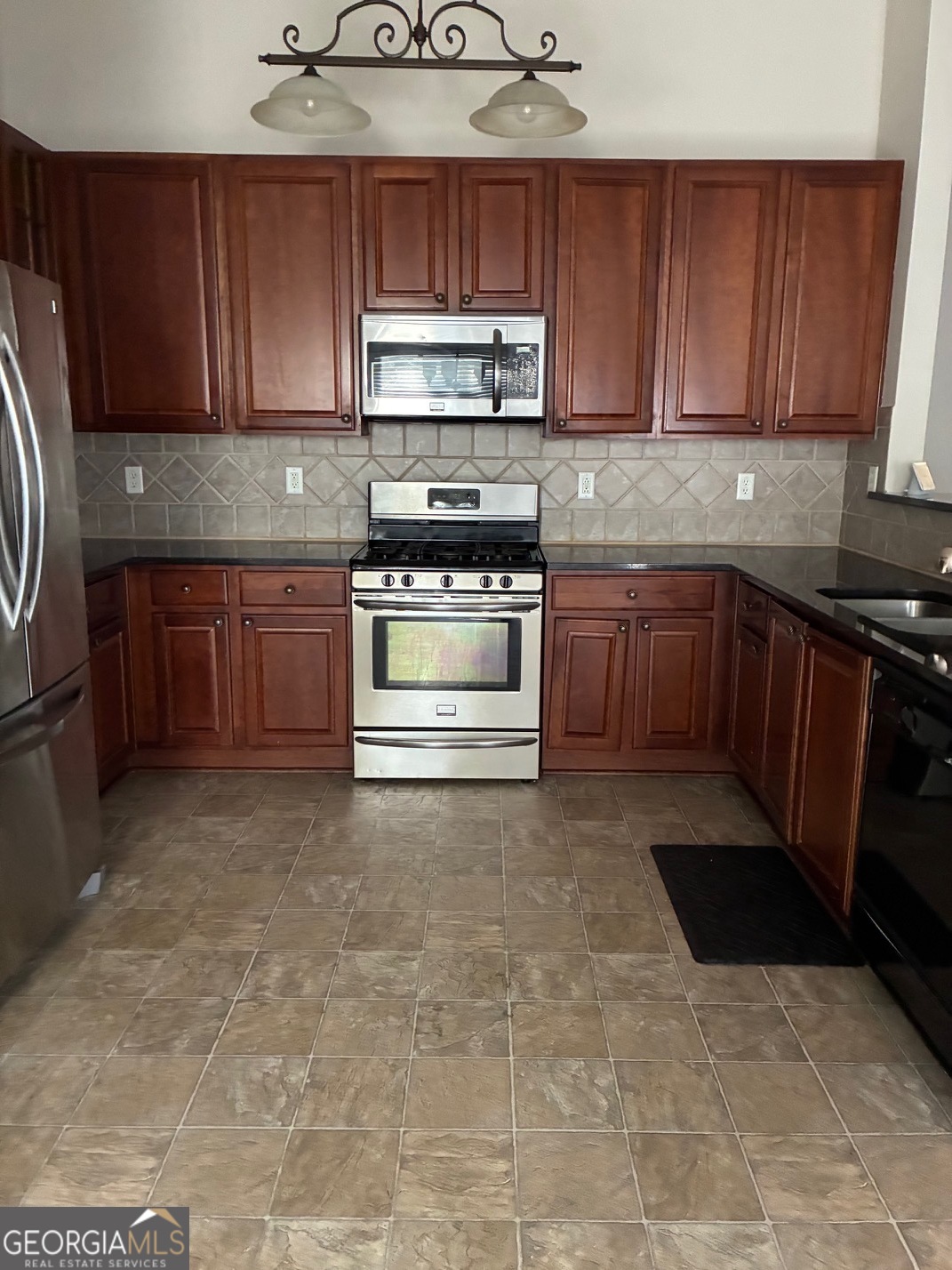 4230 Vinca Way Union City, GA 30291 - Photo 13 of 14 a kitchen with stainless steel appliances a stove a sink and a microwave