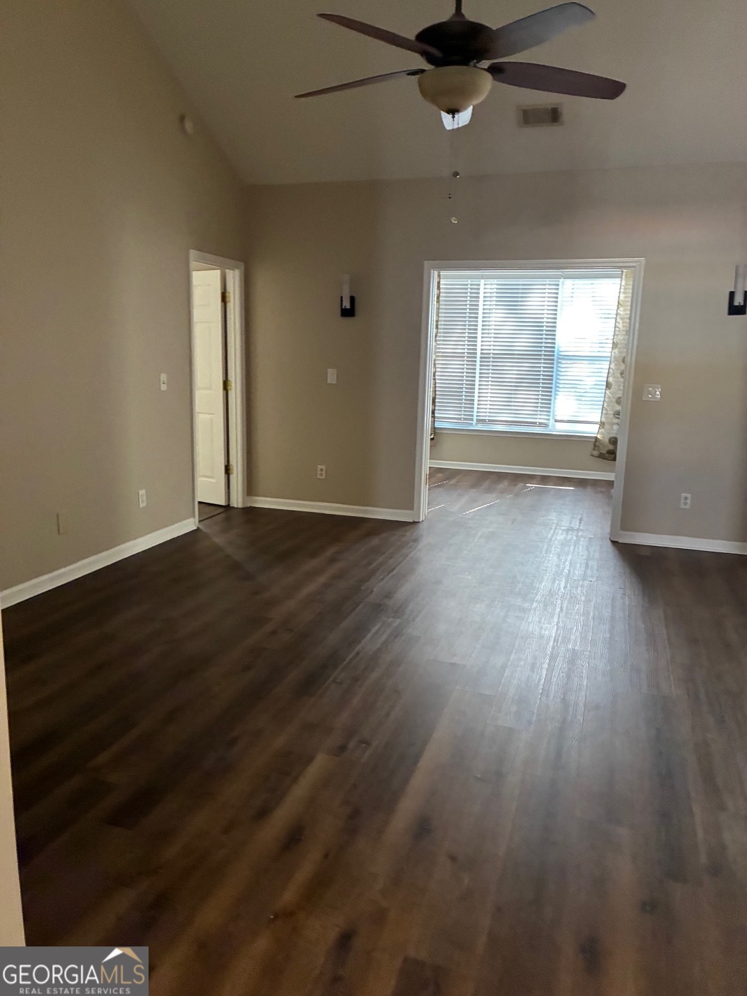 4230 Vinca Way Union City, GA 30291 - Photo 9 of 14 an empty room with wooden floor cabinet and windows
