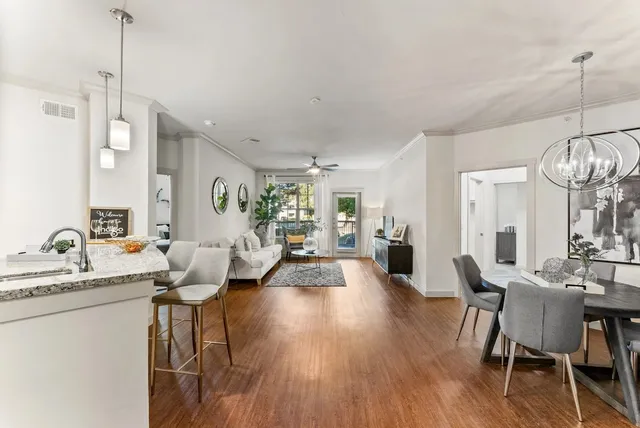 a very nice looking living room with wooden floor and furniture