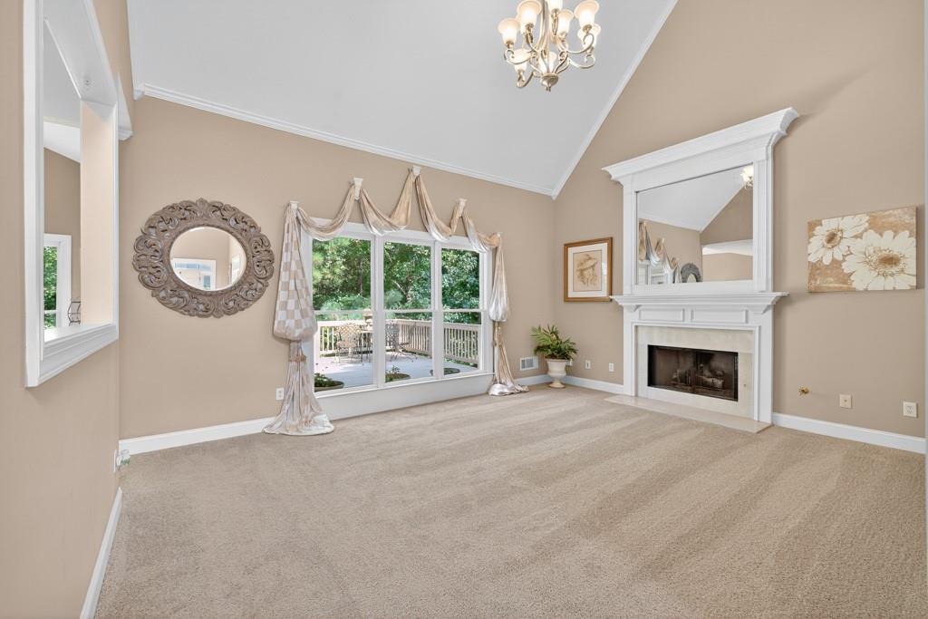 994 Fairview Club Circle Dacula, GA 30019 - Photo 11 of 57 a view of a livingroom with a fireplace a large window and a chandelier