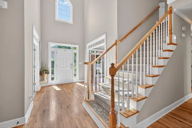 a view of staircase with wooden floor and white walls