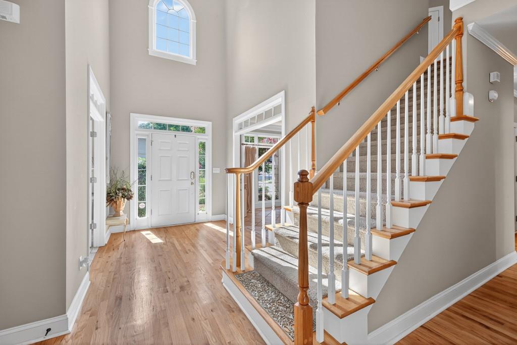 994 Fairview Club Circle Dacula, GA 30019 - Photo 13 of 57 a view of staircase with wooden floor and white walls