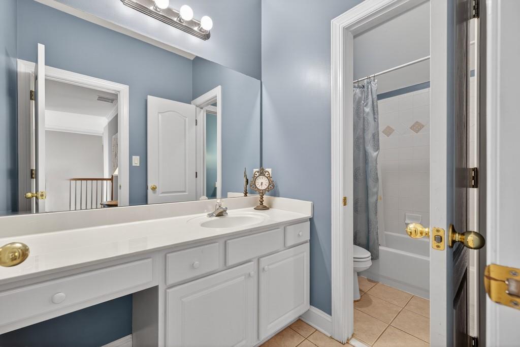 994 Fairview Club Circle Dacula, GA 30019 - Photo 22 of 57 a bathroom with a sink and mirror with toilet