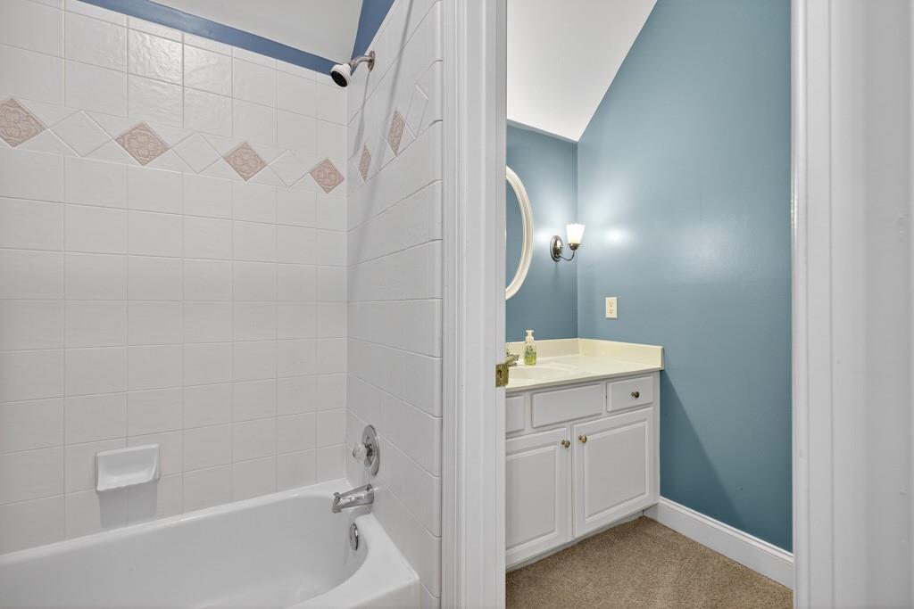 994 Fairview Club Circle Dacula, GA 30019 - Photo 23 of 57 a bathroom with a granite countertop sink a toilet and shower