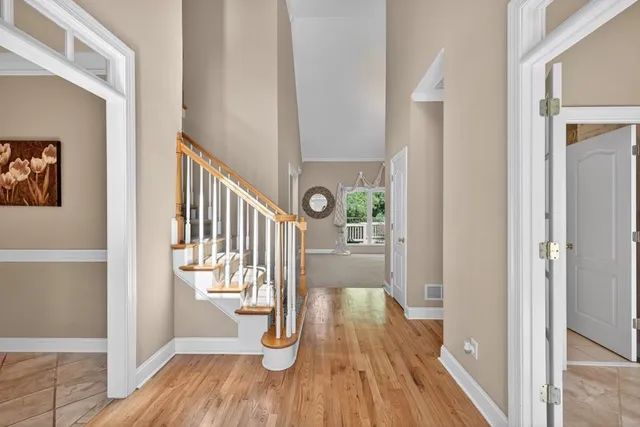 a view of a hallway with wooden floor and staircase