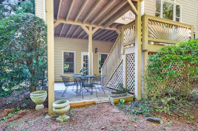 a view of a deck with table and chairs and wooden floor