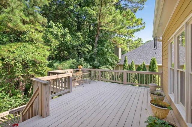 an aerial view of a houses with a yard and lake