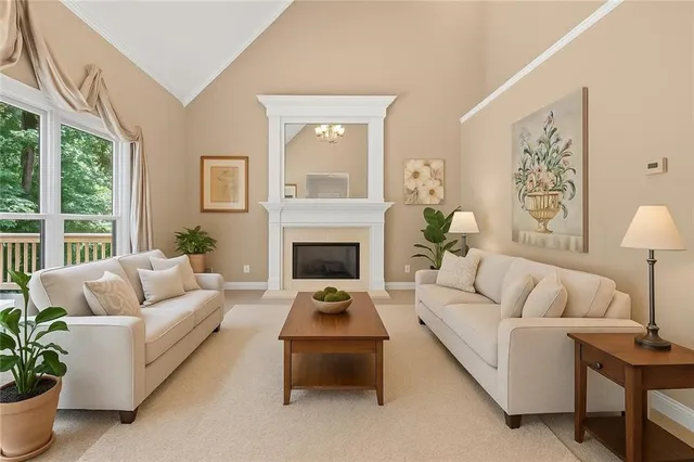 a living room with furniture fireplace and a large window