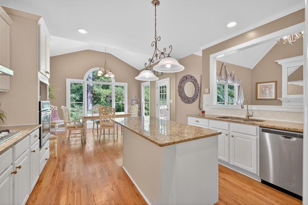 994 Fairview Club Circle Dacula, GA 30019 - Photo 7 of 57 a very nice looking dining room with a large window wooden floor and stainless steel appliances
