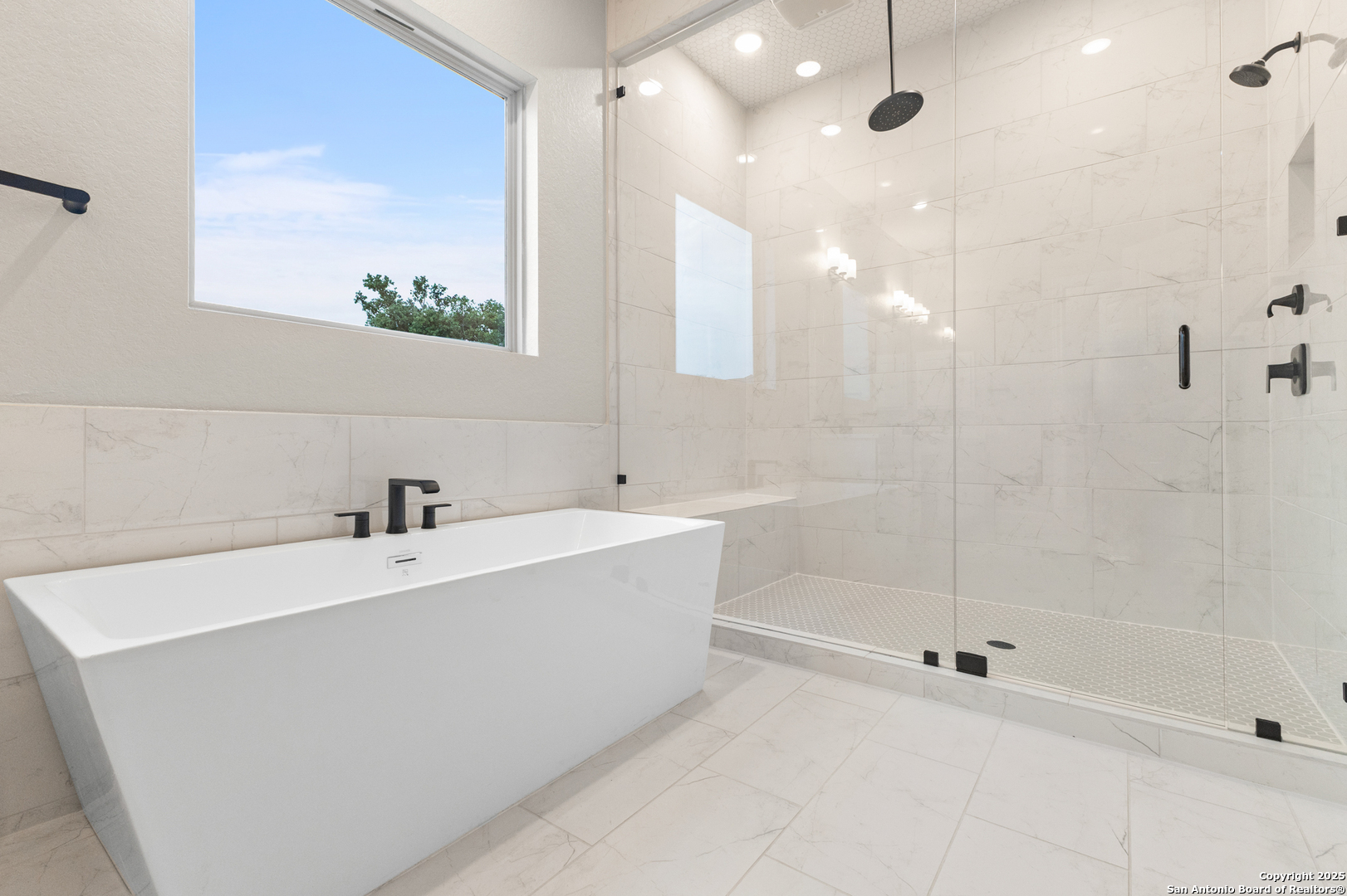 399 James Way Castroville, TX 78009 - Photo 20 of 32 a bathroom with a bathtub and a shower