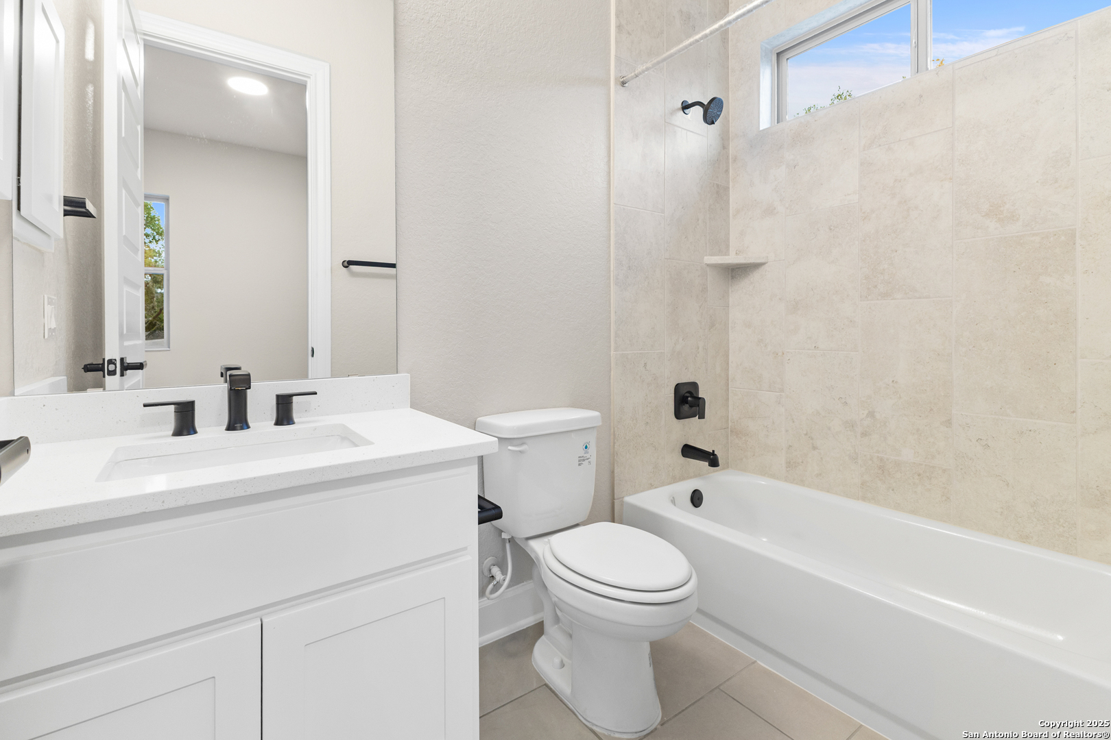 399 James Way Castroville, TX 78009 - Photo 25 of 32 a bathroom with a sink a toilet and a mirror