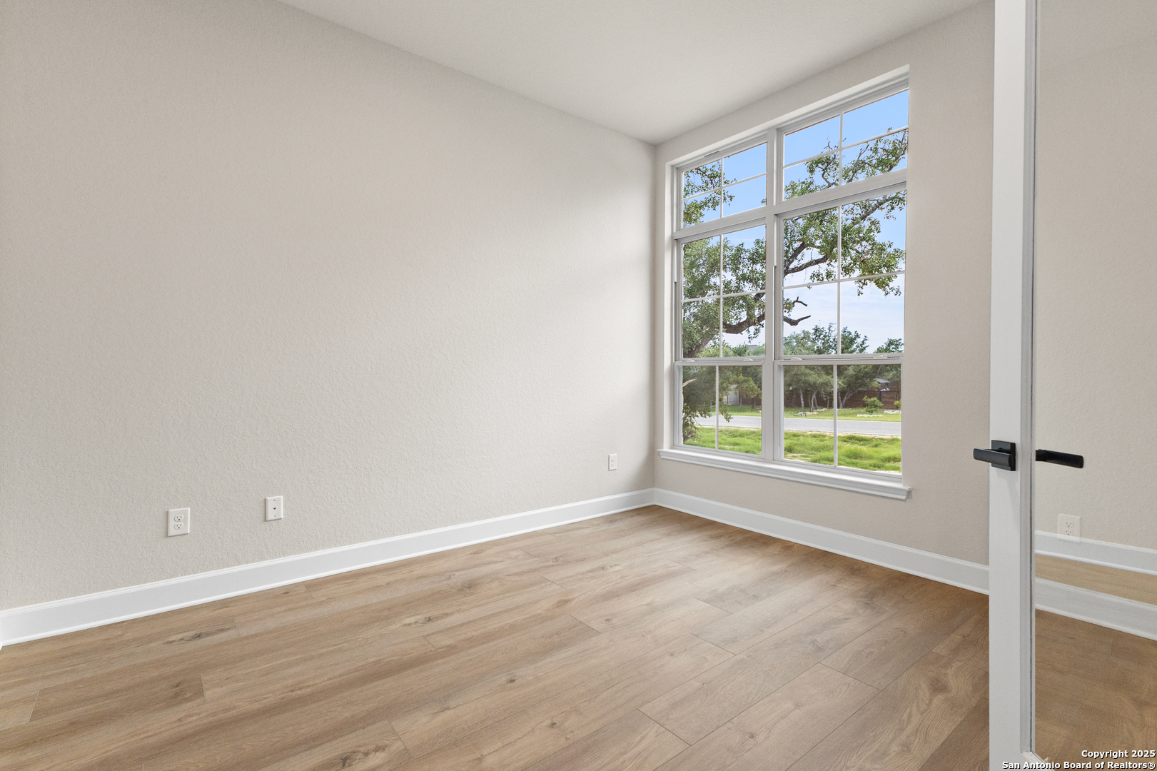 399 James Way Castroville, TX 78009 - Photo 5 of 32 a view of an empty room with a window
