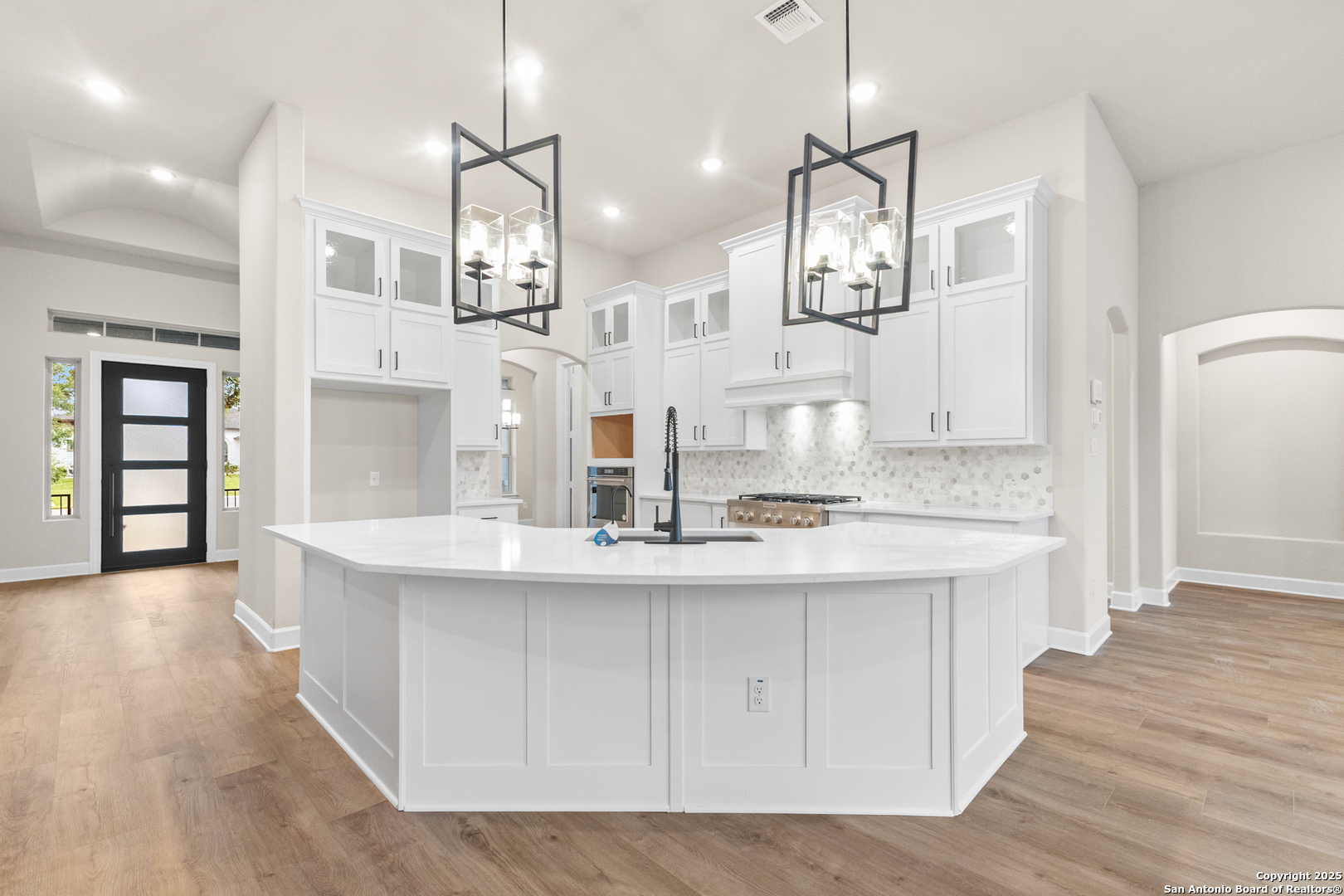 399 James Way Castroville, TX 78009 - Photo 10 of 32 a kitchen with counter top space and wooden floor