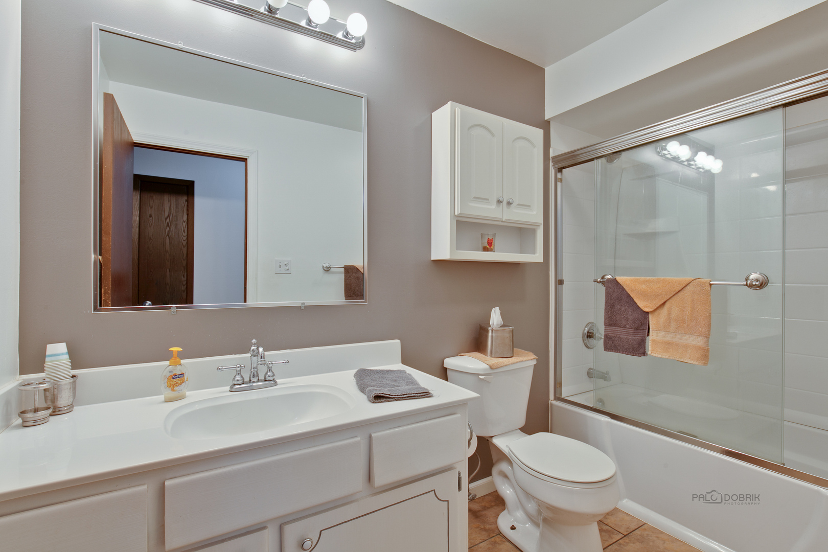 7712 Ravina Drive Spring Grove, IL 60081 - Photo 13 of 30 a bathroom with a toilet sink a mirror and vanity