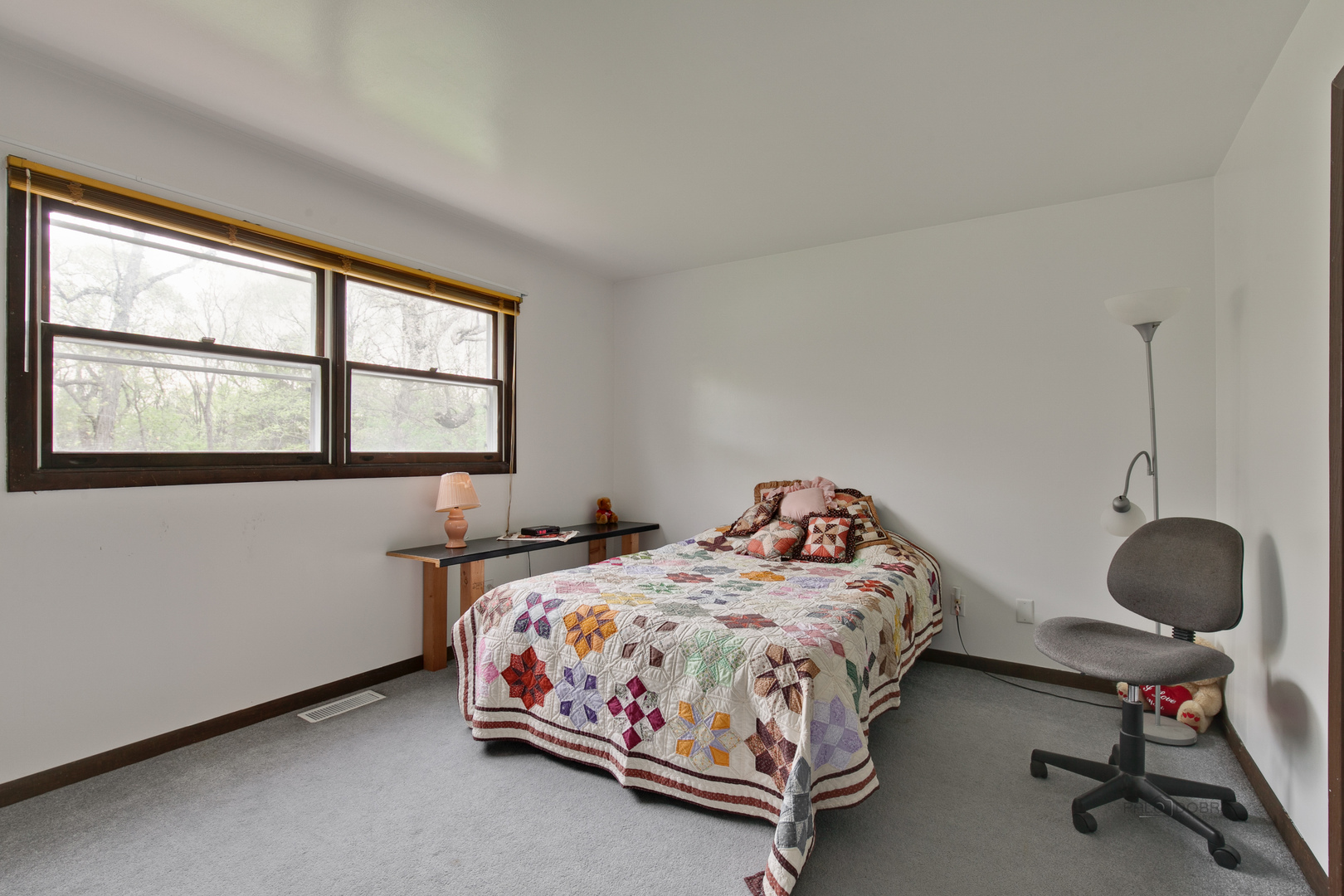 7712 Ravina Drive Spring Grove, IL 60081 - Photo 15 of 30 a bedroom with two beds and a window