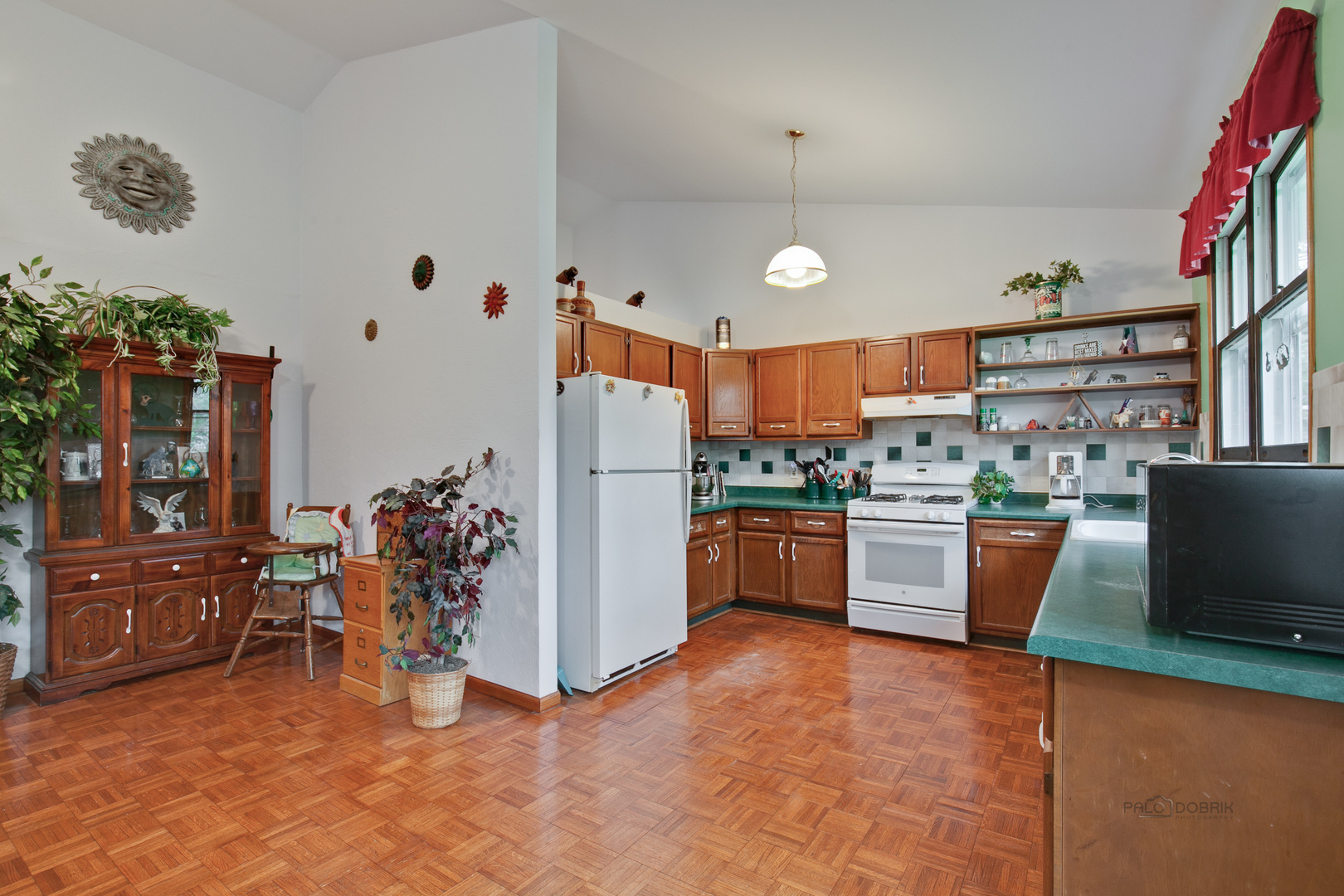 7712 Ravina Drive Spring Grove, IL 60081 - Photo 7 of 30 a kitchen with stainless steel appliances kitchen island granite countertop a refrigerator and a stove top oven