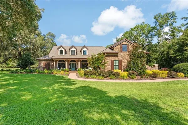 a front view of a house with a garden