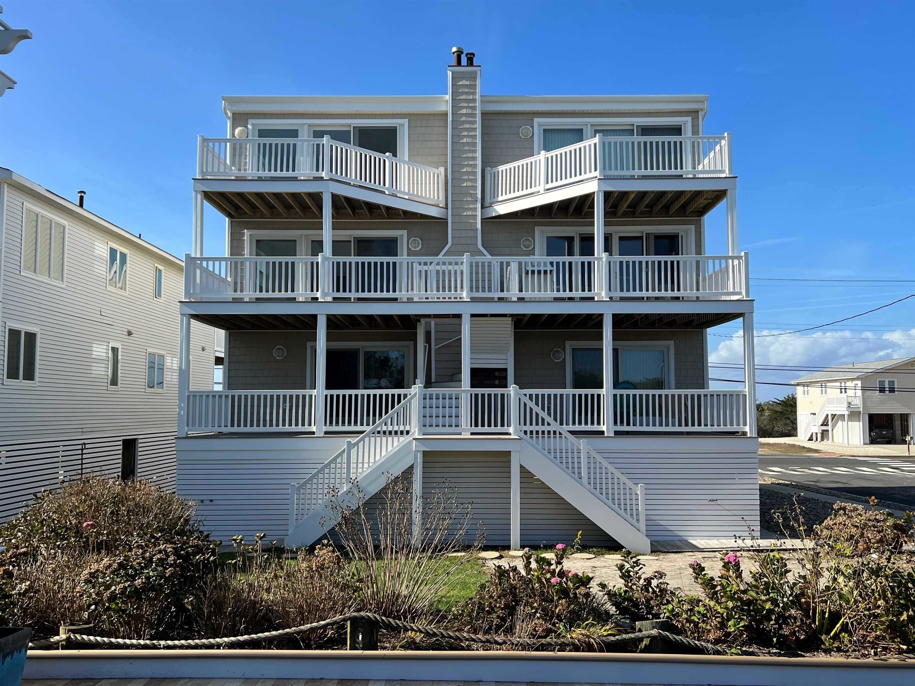 2701 Landis Avenue, Unit B SOUTH Sea Isle City, NJ 08243 - Photo 2 of 34 a front view of a house with a yard and potted plants