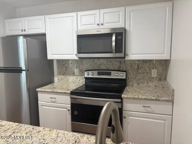 a kitchen with a stove and a microwave