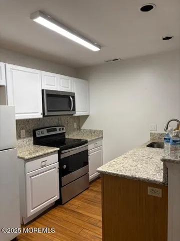a kitchen that has a sink and a stove top oven