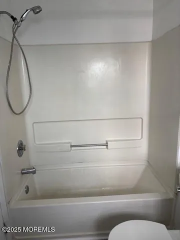 a bathroom with a bathtub and toilet
