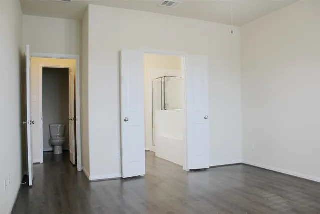 a view of a hallway with wooden floor
