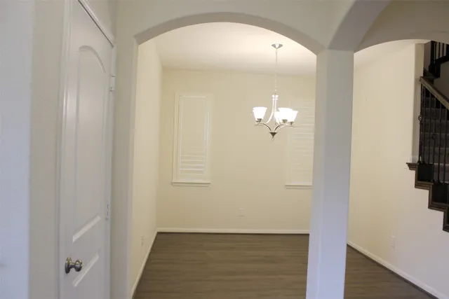 a view of a chandelier fan and wooden floor